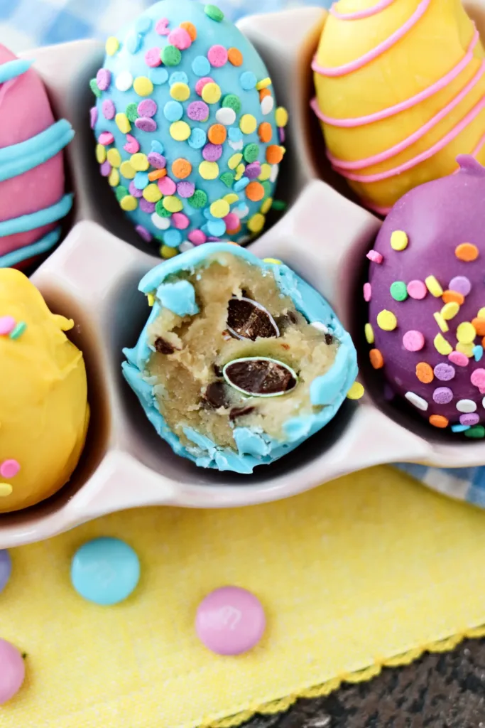easter egg shaped cookie dough balls coated in colorful chocolate and sprinkles
