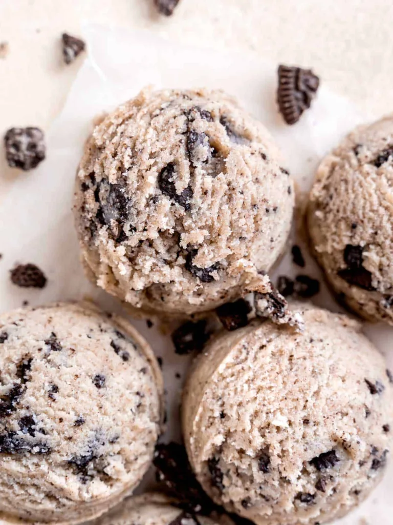 round scoops of cream-based dough with chocolate cookie crumbs scattered around